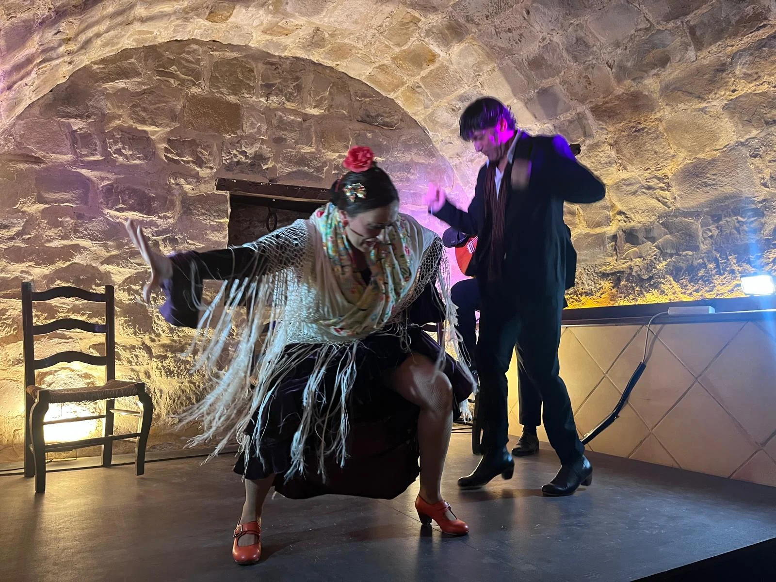 A dance duet beneath the stone vault